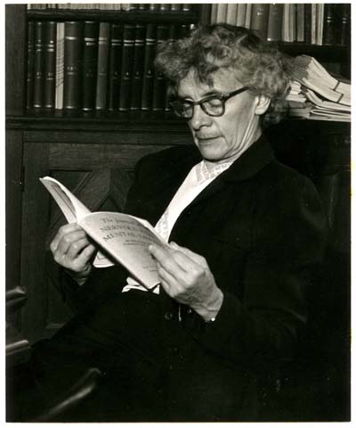 Image of Dr. Loretta Bender, seated, with an open book.
